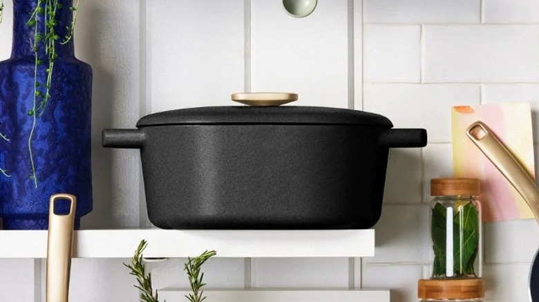 Black Dutch oven on a shelf in the kitchen