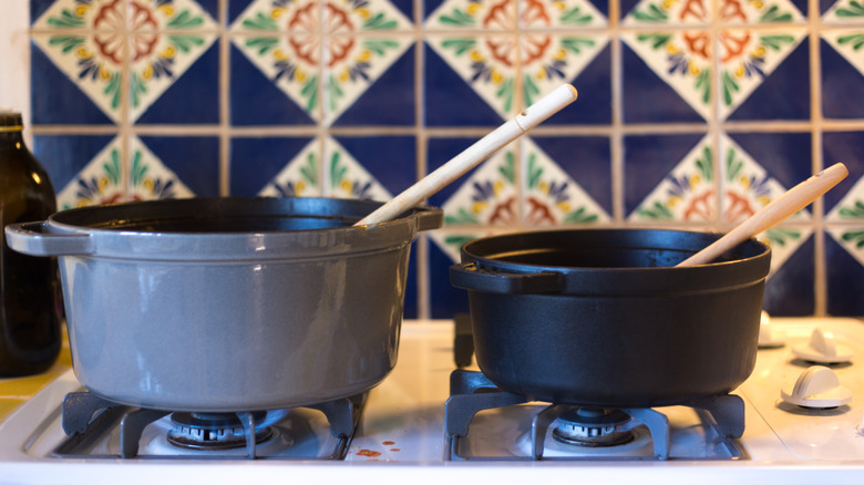 Enameled cookware on a lit gas oven