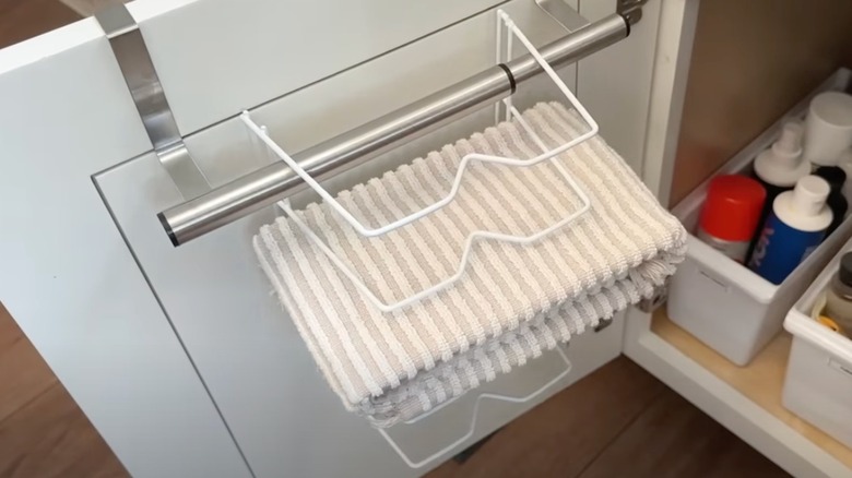 A DIY hanging towel organizer under the kitchen cabinet.