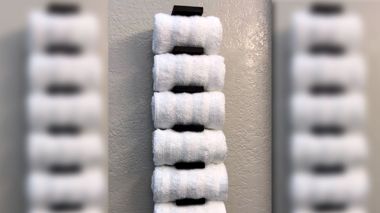 A seven-slot towel DIY holder made from Dollar Tree items.