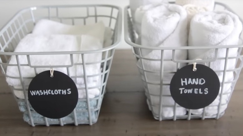 Washcloths and hand towels organized into labeled baskets.