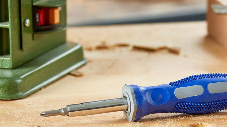 A blue Pittsburgh 6-in-1 nut driver snapped on a workstation.