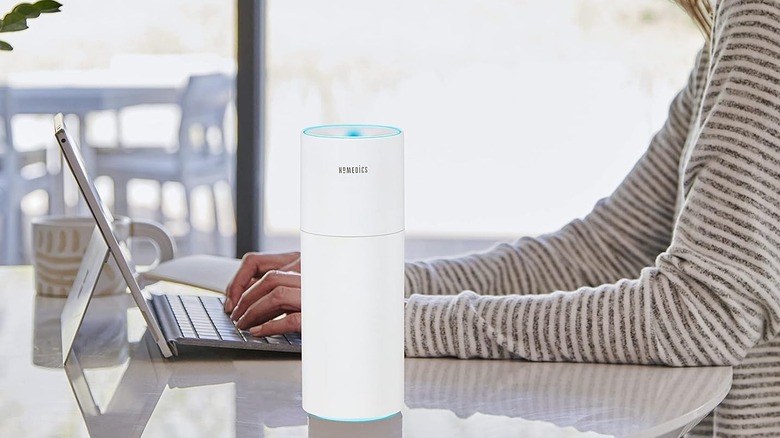 HoMedics Portable Humidifier sitting on a table where someone is working