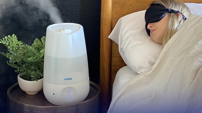 Vicks FilterFree Plus Cool Mist Humidifier sitting on a bedside table