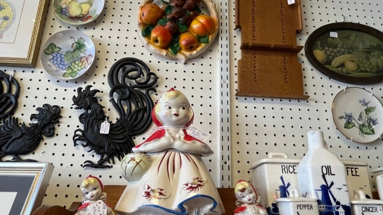 Figurines and other ceramic items on display at a thrift store.