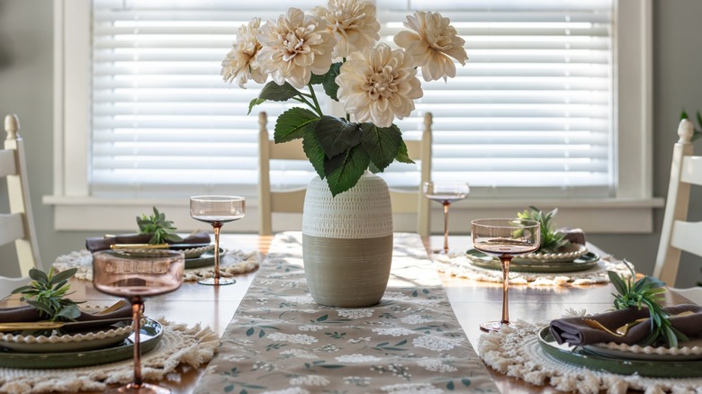 A lovely floral arrangement as a centerpiece of a tablescape.