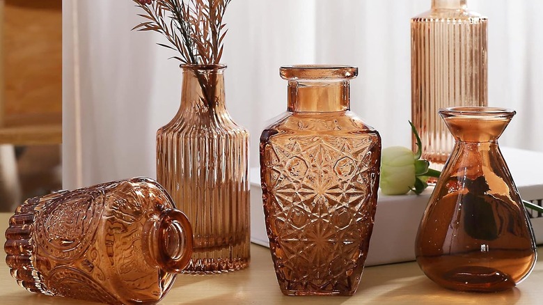 Five amber glasses with different textures on countertop