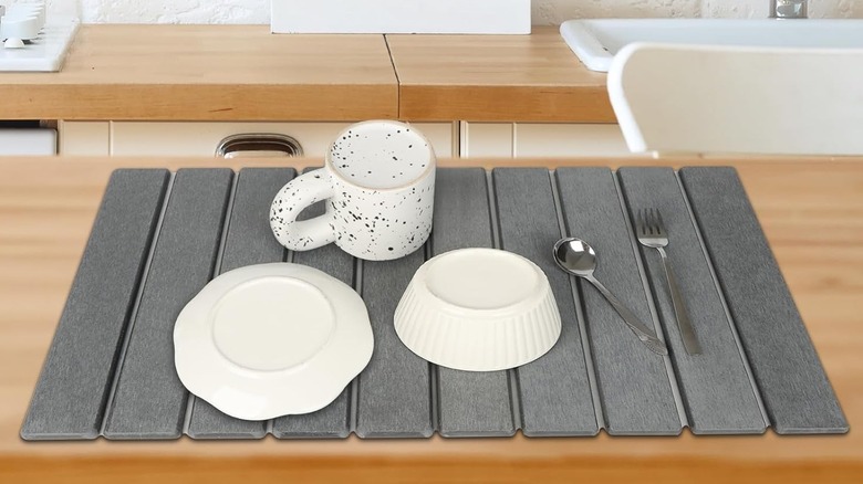 Gray stone drying mat with dishes on top