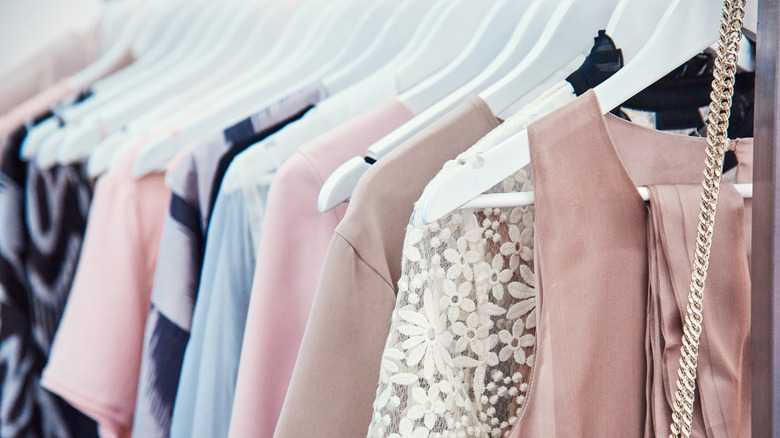 Organized clothes on white wooden hangers