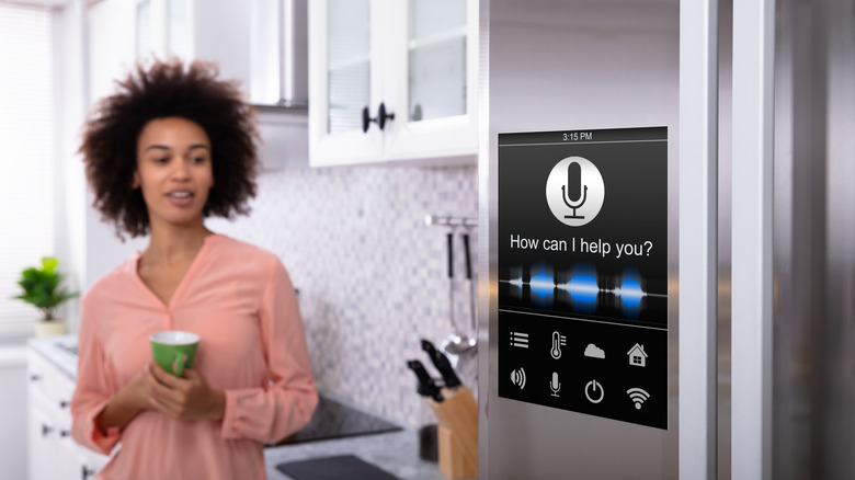 Woman using smart fridge