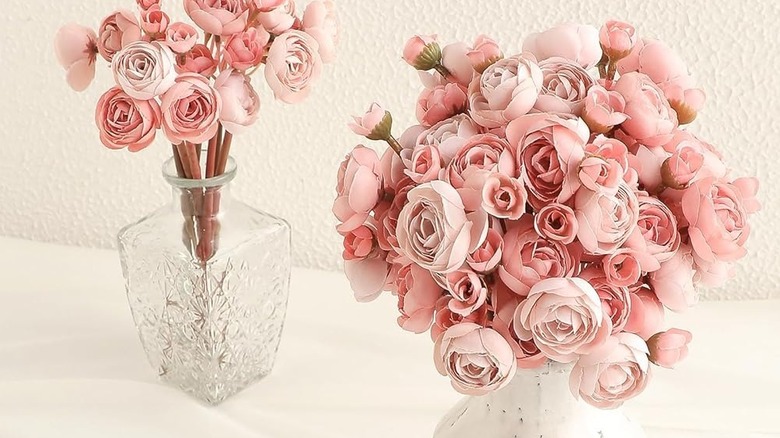 Faux pink ranunculus in clear vases