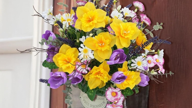 Artificial spring wildflowers on a front door planter