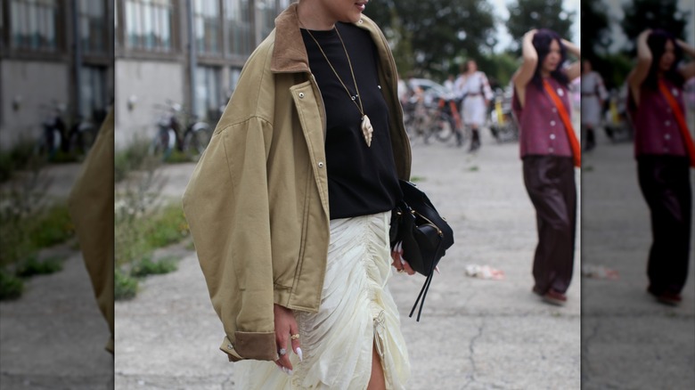 Woman wearing barn jacket over shoulders