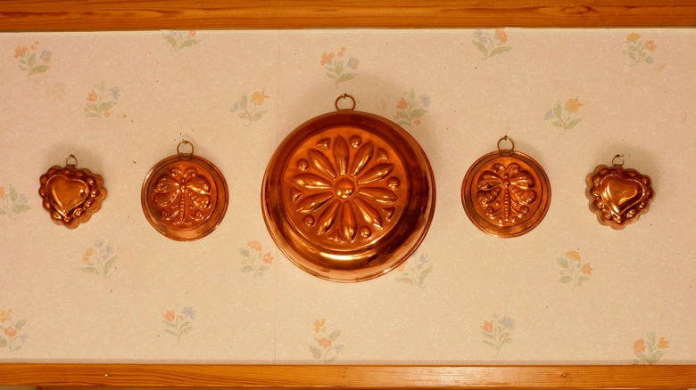 Vintage copper molds hanging on wall
