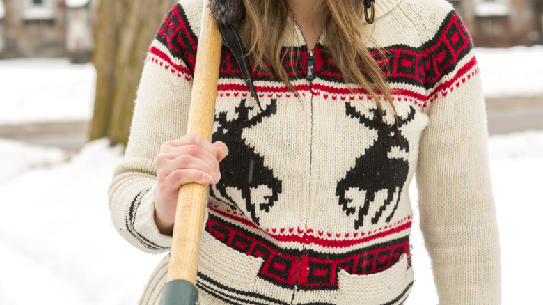 Woman wearing vintage white sweater with reindeer