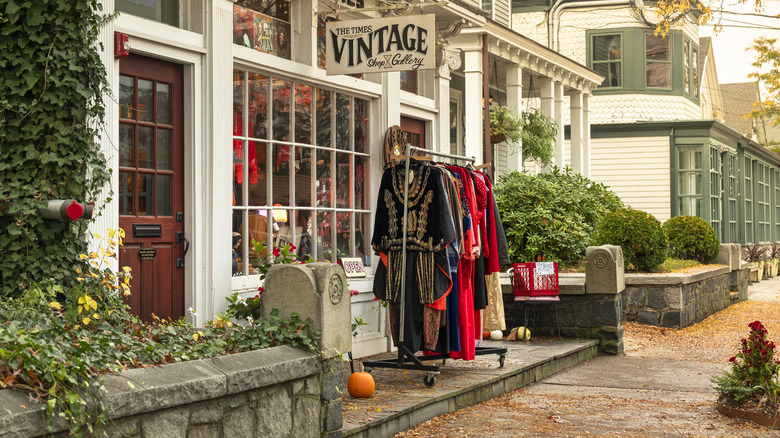 Vintage store exterior with dress rack and pumpkins outside