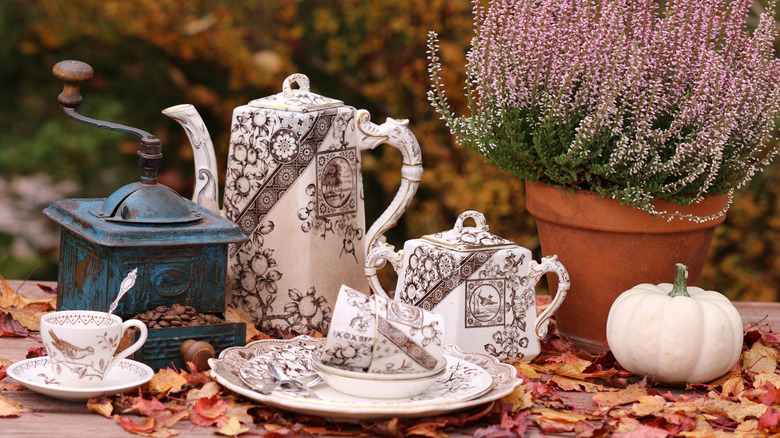 Transferware tea set in fall scene with antique coffee grinder