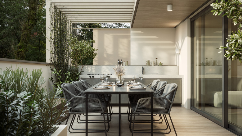 outdoor patio dining area with kitchen and sliding doors
