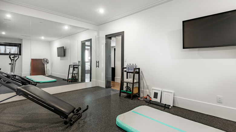 Home gym with black floor and white walls