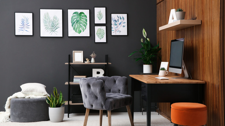 Home office with dark gray wall and wood accent wall