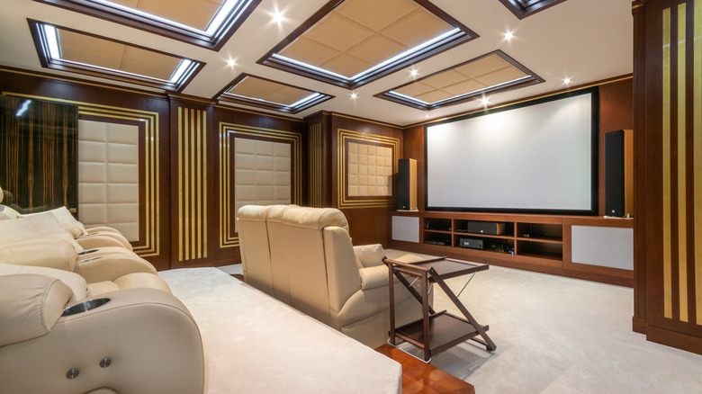 Home theater with large screen and beige recliners