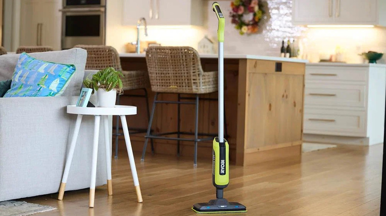 Ryobi's USB Lithium Cordless Agitating Spray Mop standing by itself in a living room