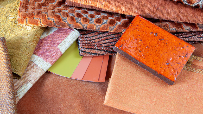 A terracotta tile sample paired with a design scheme
