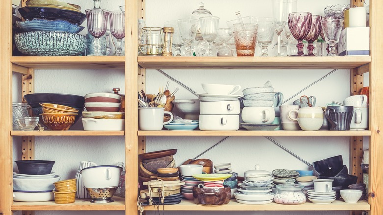 cluttered shelves with dishware