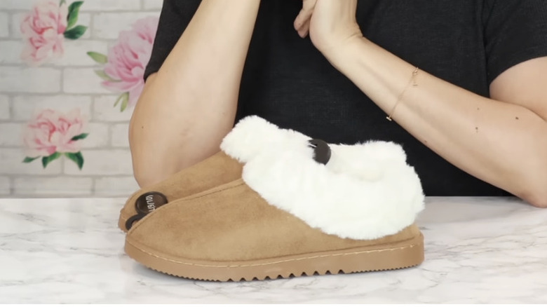 house slippers sitting on counter with woman standing behind