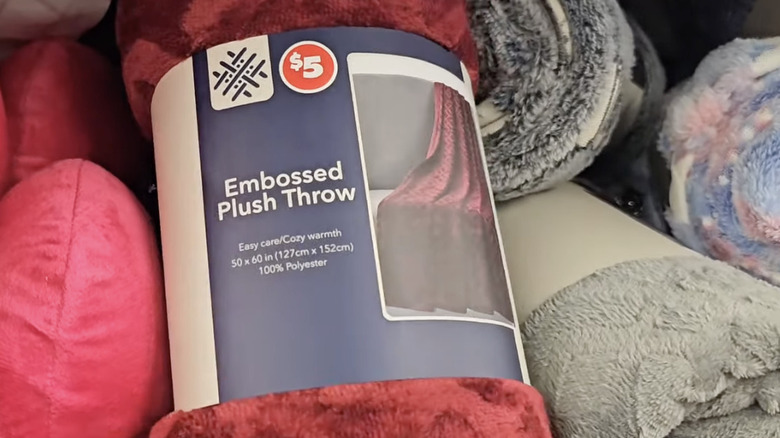 Rolled up throw blankets on the store shelf