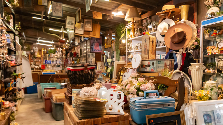 An antique store with art, hats, and other vintage items.