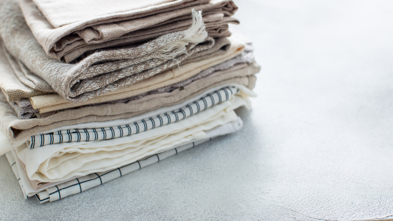 Close-up of linen dish towels folded on kitchen counter