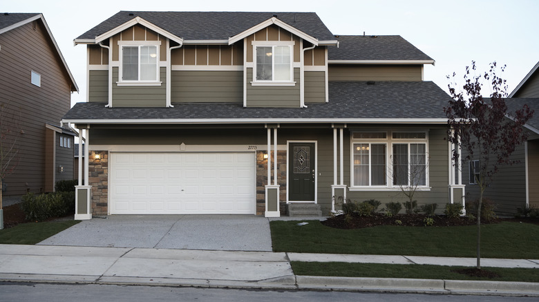 green suburban home black roof