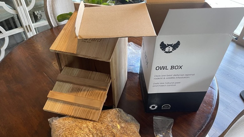 WildYard owl nesting box and shavings sitting on a kitchen table