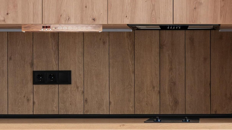 A folded mahogany SYLVOX tv under cabinets.