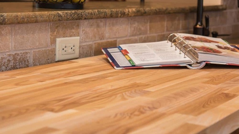 Ash wood butcher block countertop with open recipe book on top