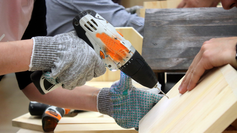 People in a workshop working together to build bird feeders