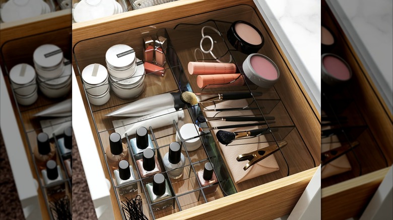 VISSLAÅN box with compartments holding makeup and nail polish