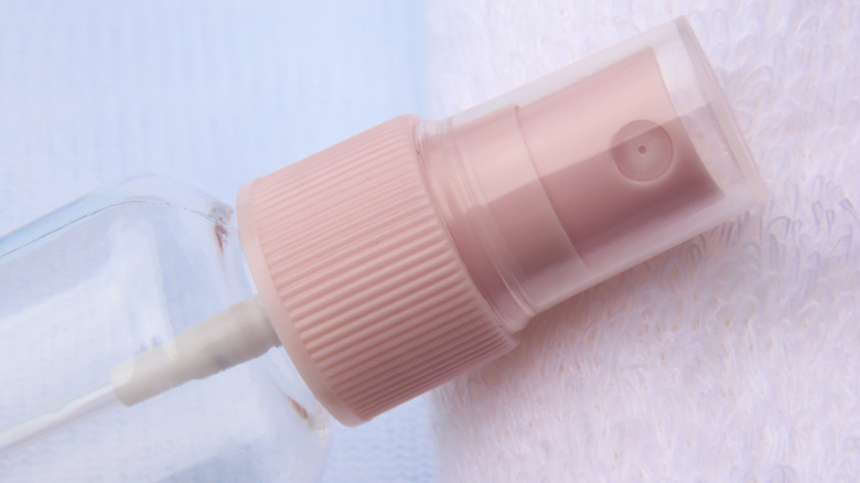 Spray bottle laying against toweling