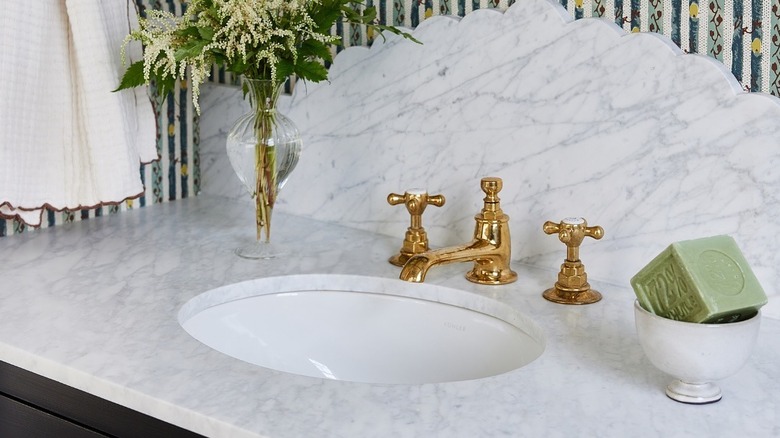Cube of olive oil soap on a marble bathroom counter