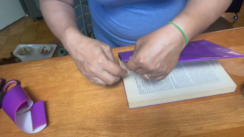 A person making book cover