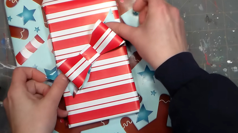 A bow on a gift made from leftover wrapping paper