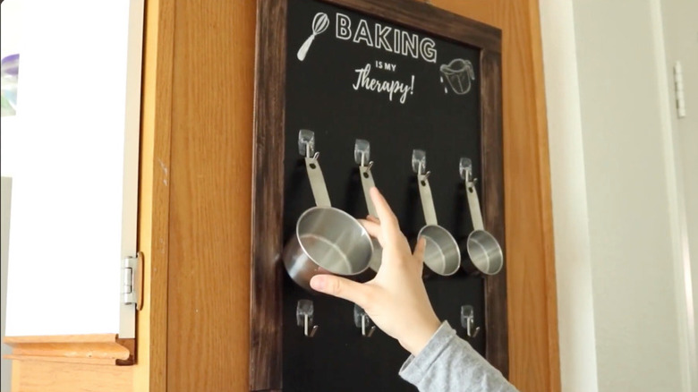 A farmhouse wall decor with hanging measuring cups