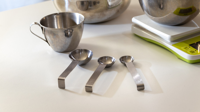 metal measuring utensils on countertop