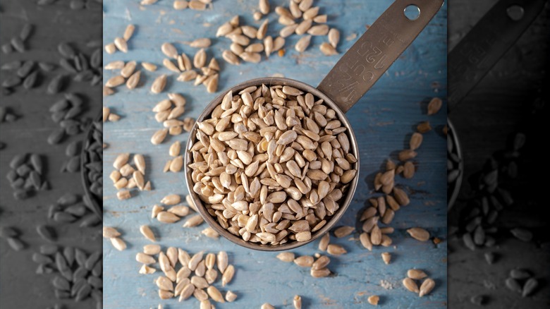 a measuring cup filled with seeds
