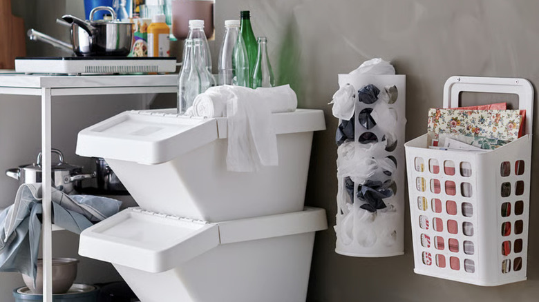An IKEA VARIERA bag dispenser hanging on a wall between other storage solutions