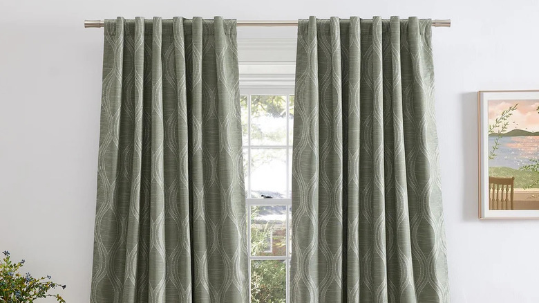 A green patterned blackout curtain set framing a large window