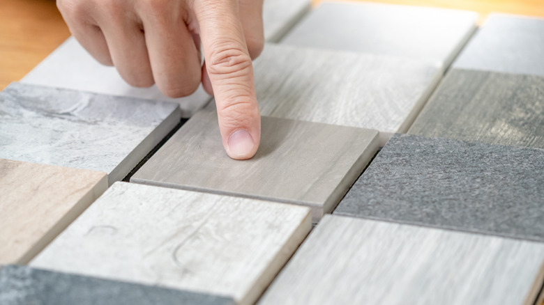 Person selecting veined stone samples