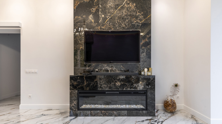 dark marble surrounding modern fireplace