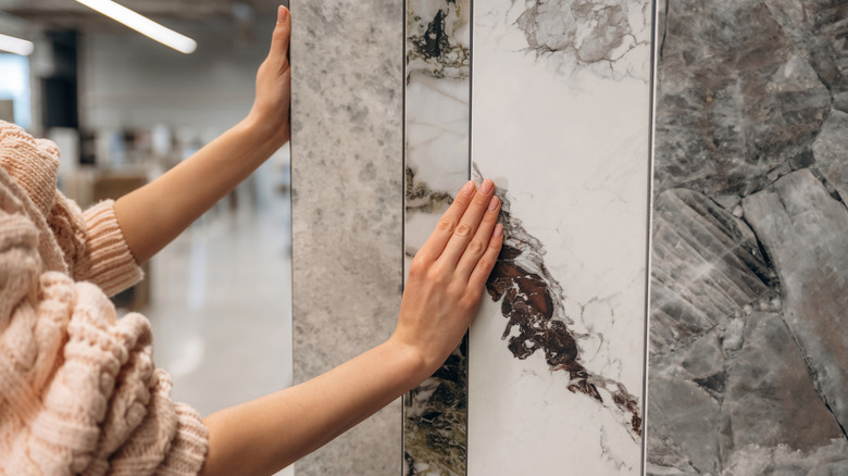 woman examining different marble options